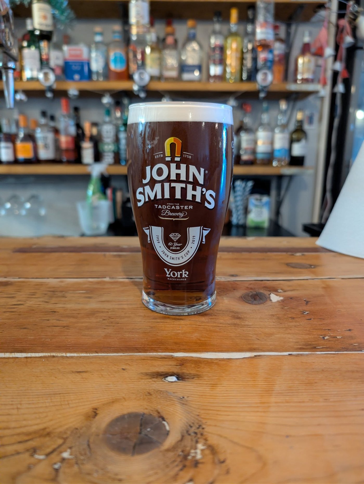 A pint of English bitter — the malt-leaning British original of the pale ale family, counterpart to the citrus-hopped American pale ale.