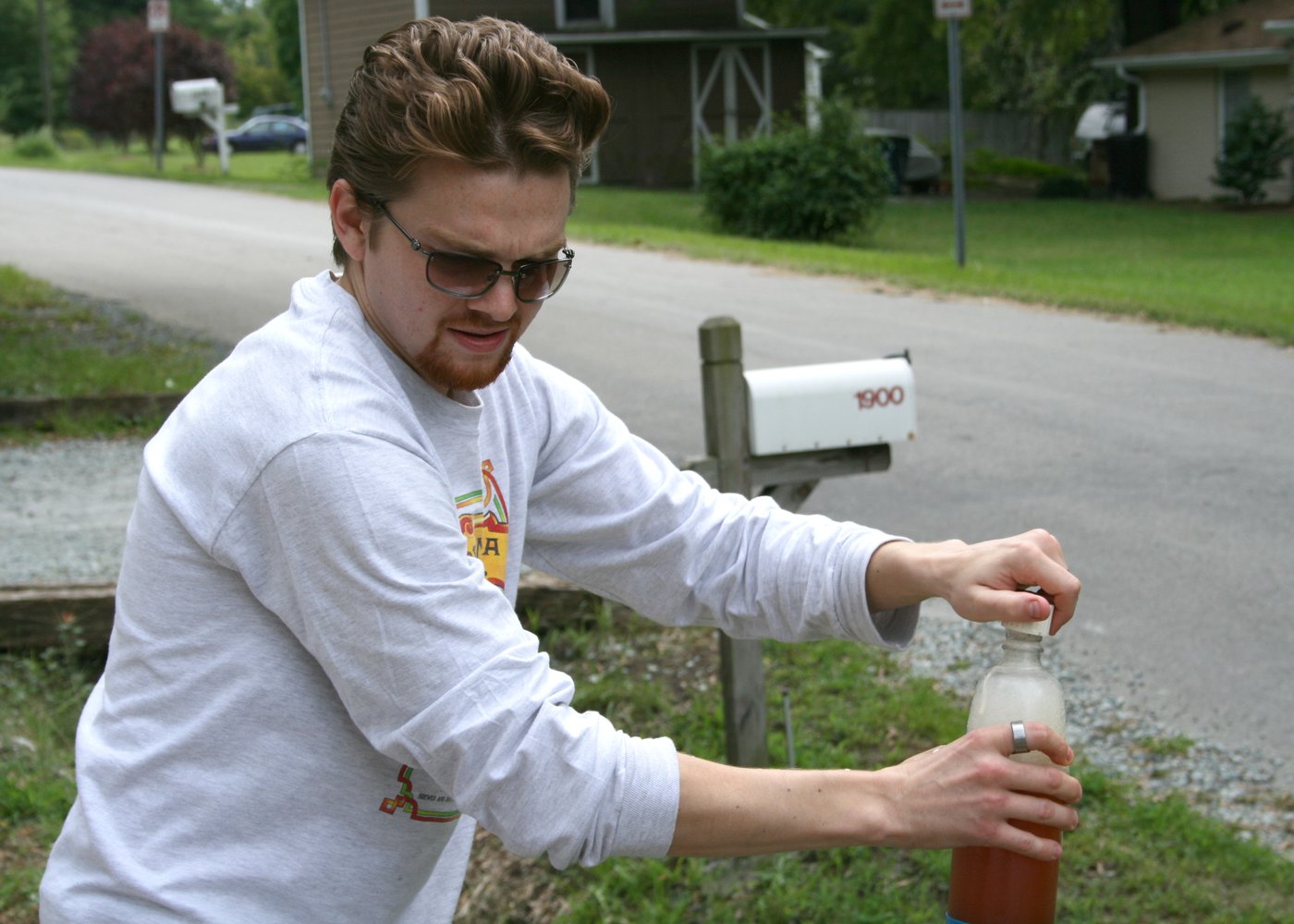 The payoff: an opened bottle of finished homebrew. Bottle-conditioned beer carbonates itself from a measured dose of priming sugar.