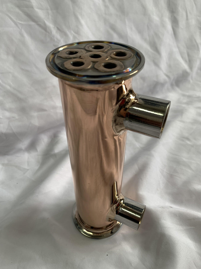 OakStills 2" pure-copper dephlegmator — coil-in-shell construction with tri-clamp fittings; the cooling-water inlet/outlet on the side control reflux ratio (reference only, vendor copyright)